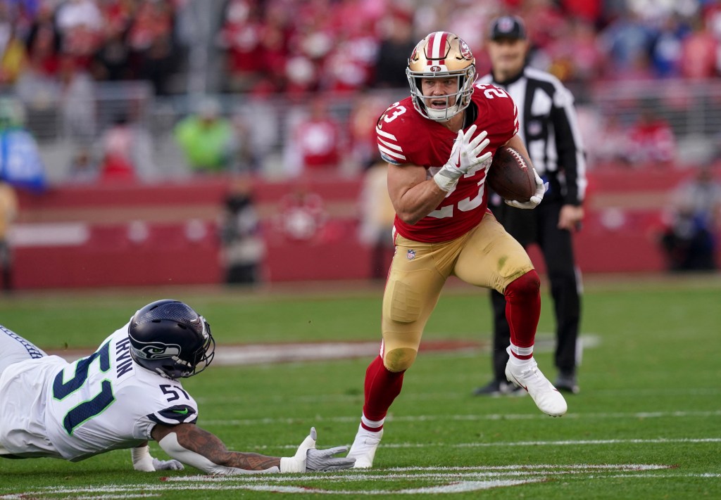 San Francisco 49ers running back Christian McCaffrey (23) gets past Seattle Seahawks linebacker Bruce Irvin (51) in the second quarter during a wild card game at Levi's Stadium.