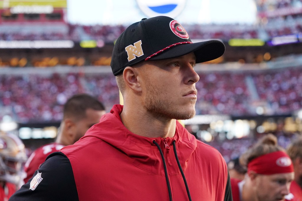 San Francisco 49ers running back Christian McCaffrey (23) watches from the sideline due to injury during the second quarter against the New York Jets at Levi's Stadium.