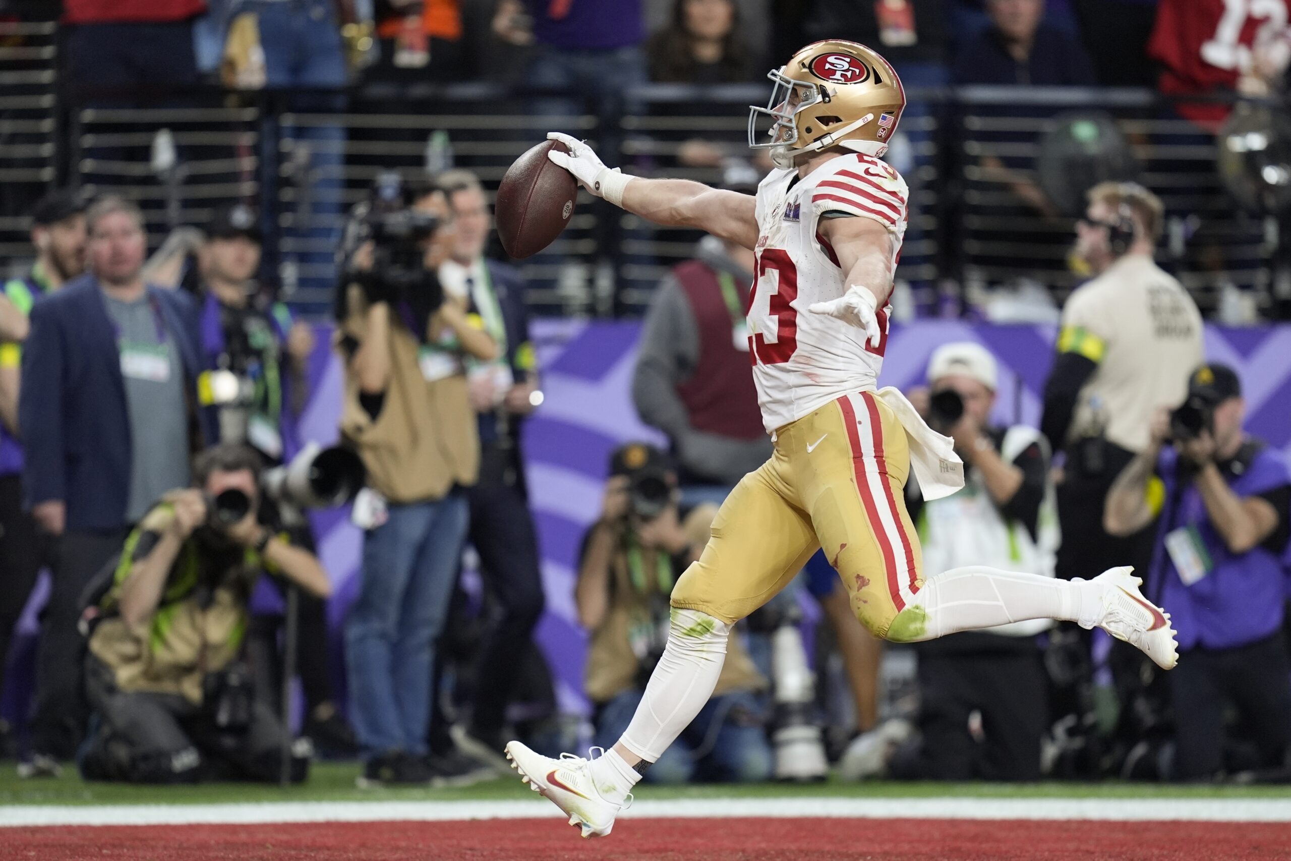 San Francisco 49ers running back Christian McCaffrey (23) scores a touchdown against the Kansas City Chiefs during the first half of the NFL Super Bowl 58 football game Sunday, Feb. 11, 2024, in Las Vegas.