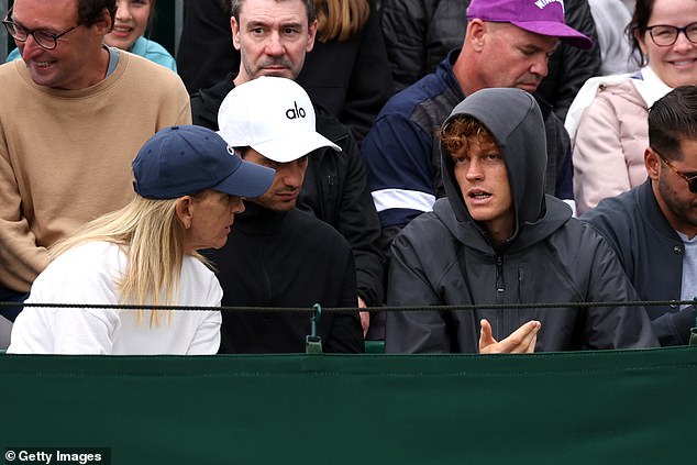 Sinner had his hood up as he watched his partner on day two of proceedings at Wimbledon