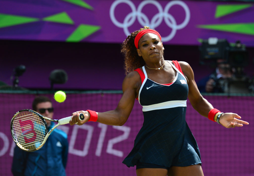 Serena Williams  of the US hits a return to Russia's Maria Sharapova during their final tennis match as part of the  2012 London Olympic Games at t...