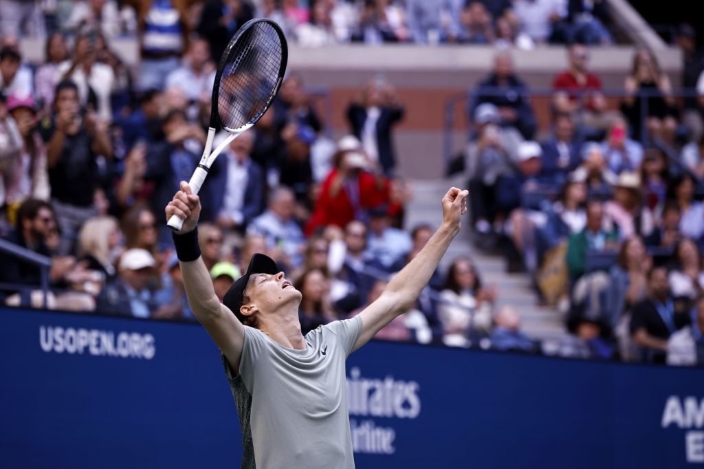 Jannik Sinner of Italy celebrating his victory at the US Open Tennis Championships with a tennis racket in hand