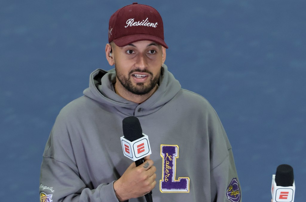 Nick Kyrgios commenting for ESPN at the 2024 US Open Tennis Championships, holding a microphone