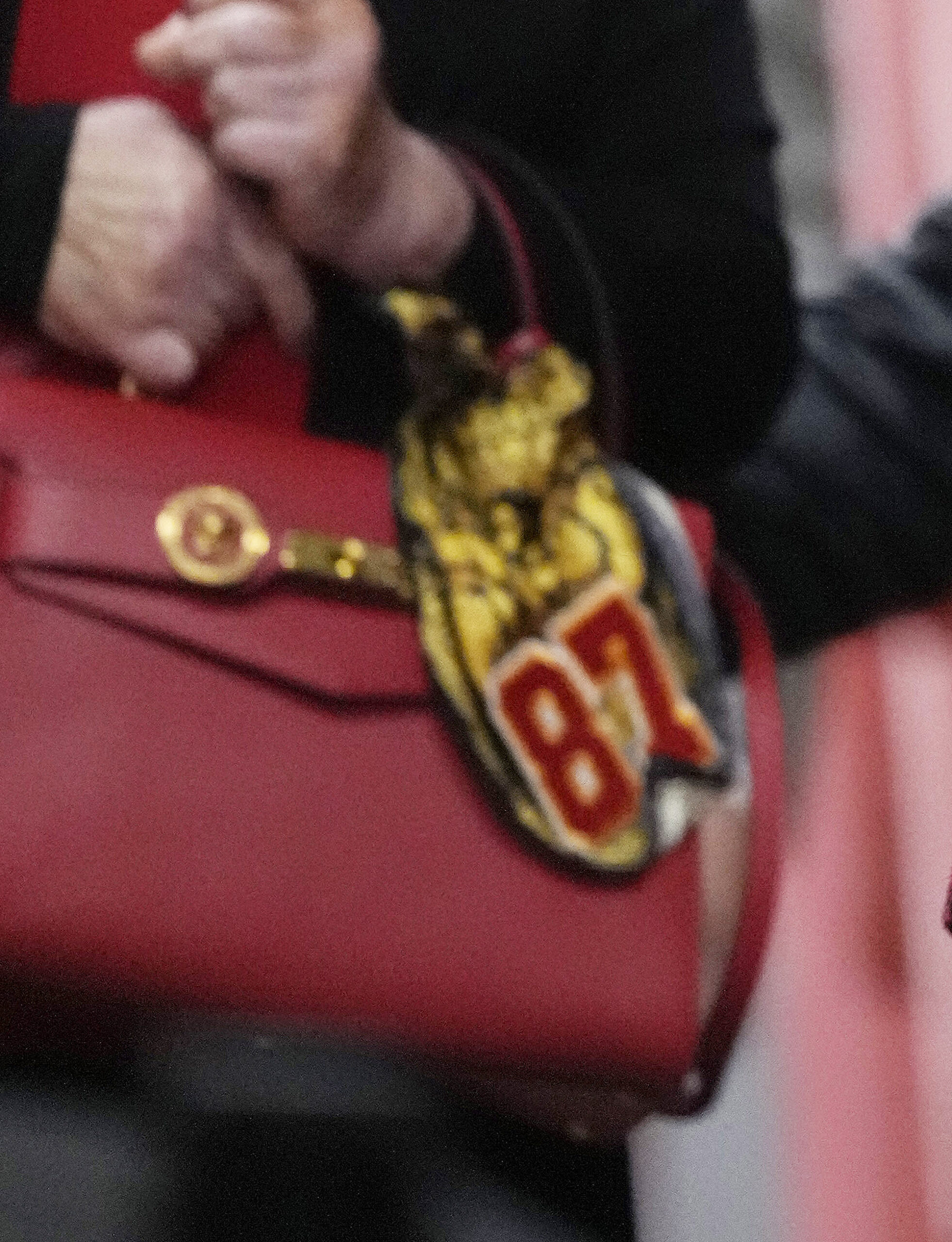 Andrea Swift's purse with a yellow scarf on it