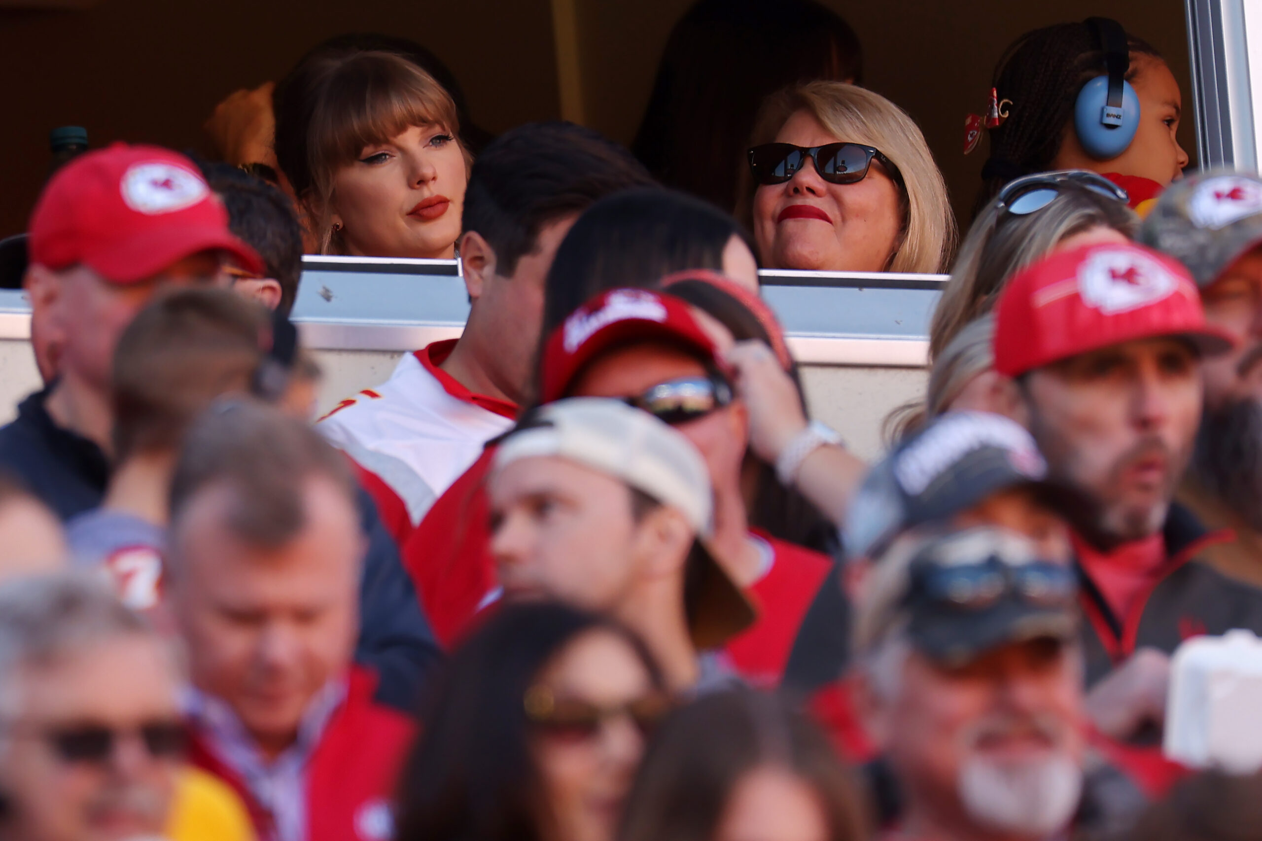 Taylor Swift and Andrea Swift sitting together at a football game